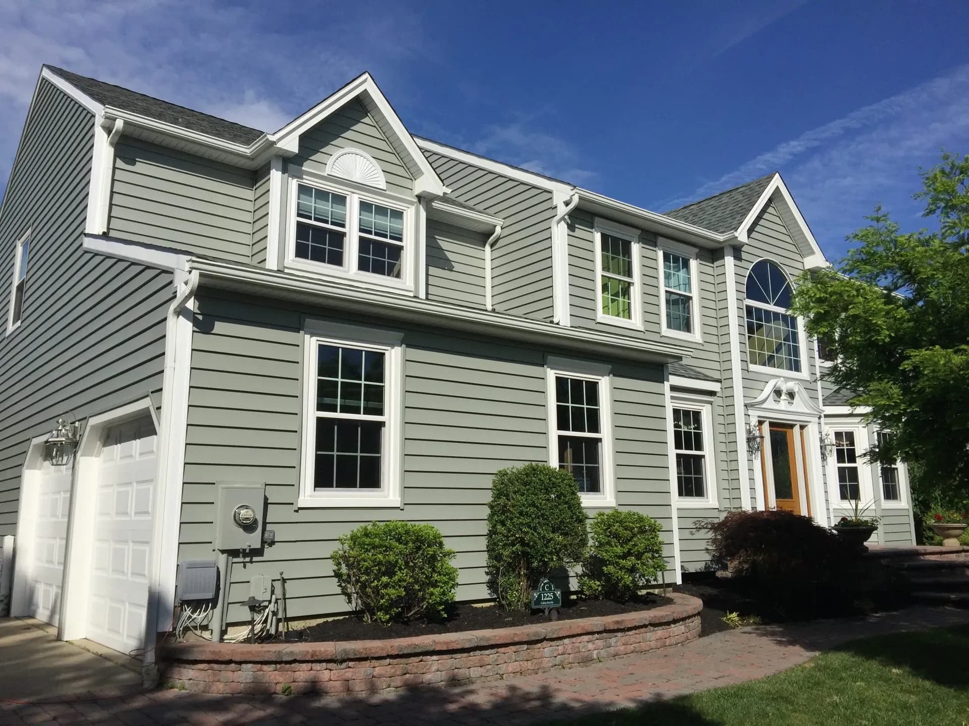 Light green siding on home with many casement windows